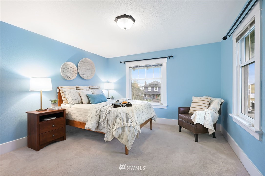 1509 Rucker Avenue Everett, WA 98201 - Photo 16 of 39 a bedroom with a bed and a chair