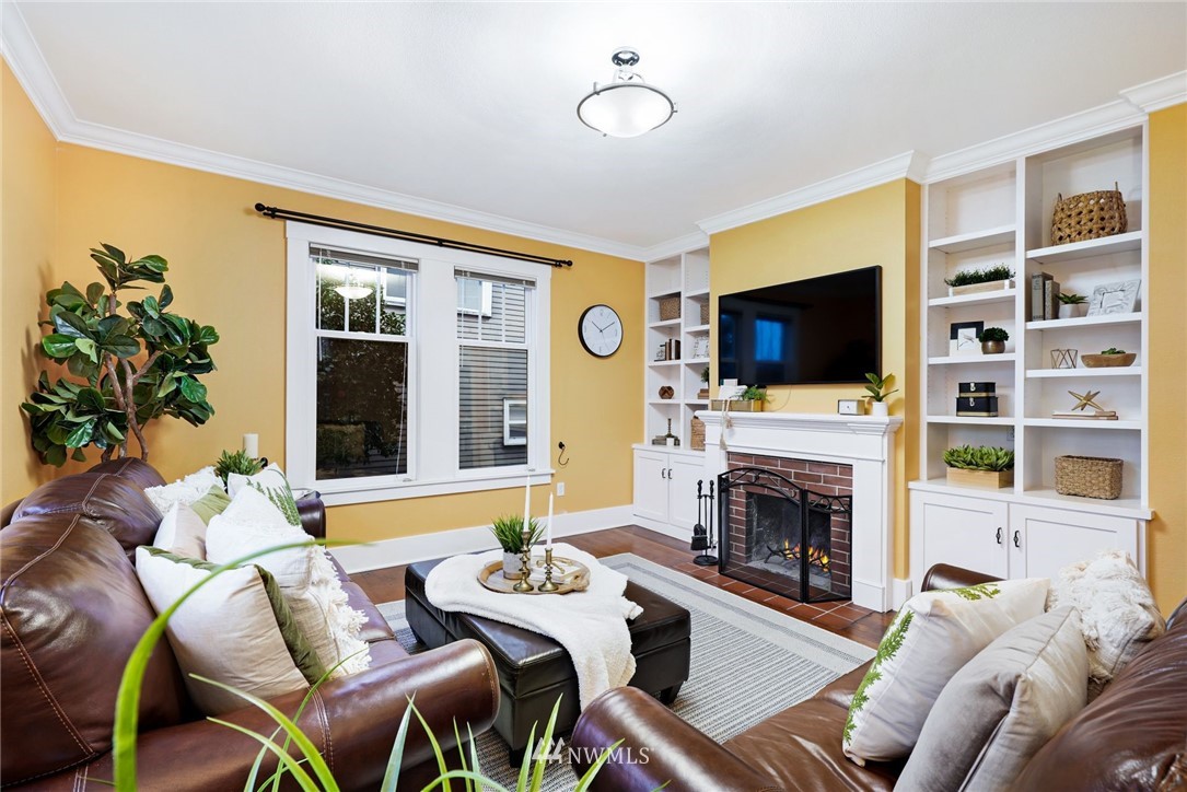 1509 Rucker Avenue Everett, WA 98201 - Photo 3 of 39 a living room with furniture a fireplace and a flat screen tv