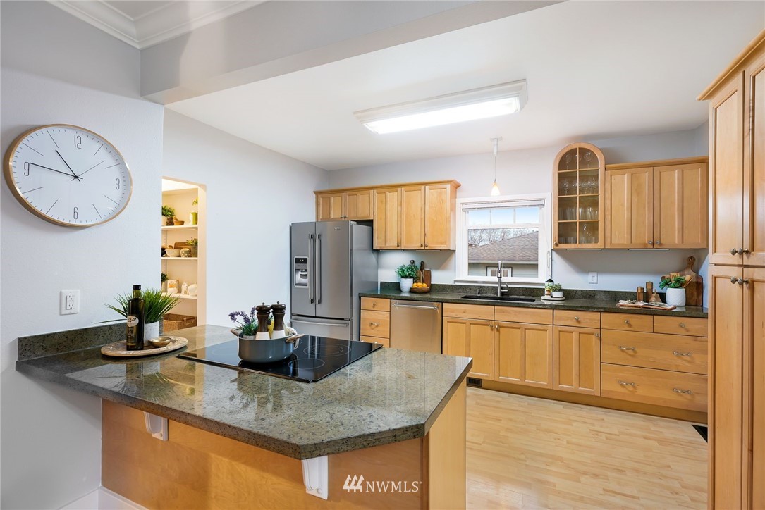 1509 Rucker Avenue Everett, WA 98201 - Photo 9 of 39 a kitchen with stainless steel appliances granite countertop a sink a stove granite counter tops and a view of living room