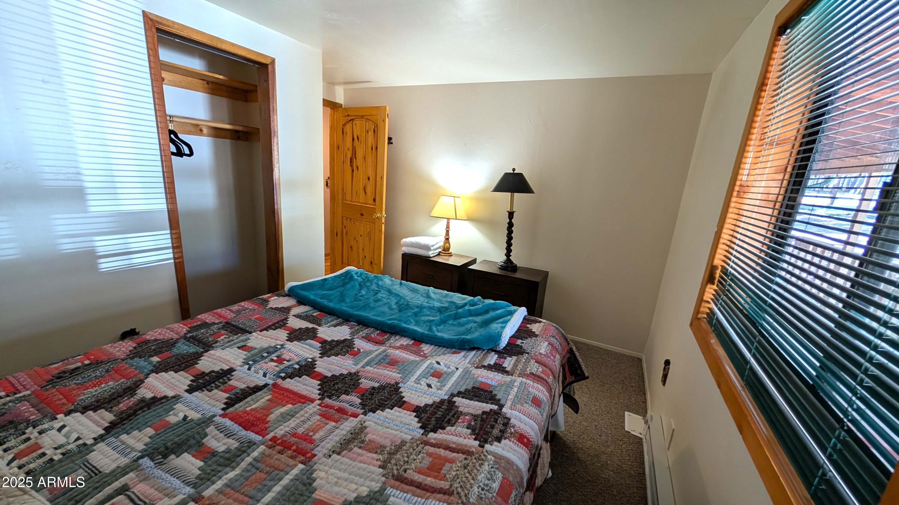 2425 Tall Trees Loop Forest Lakes, AZ 85931 - Photo 23 of 43 a bedroom with a bed and a walk in closet