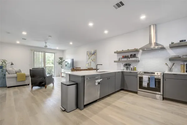 a large kitchen with stainless steel appliances lots of counter top space