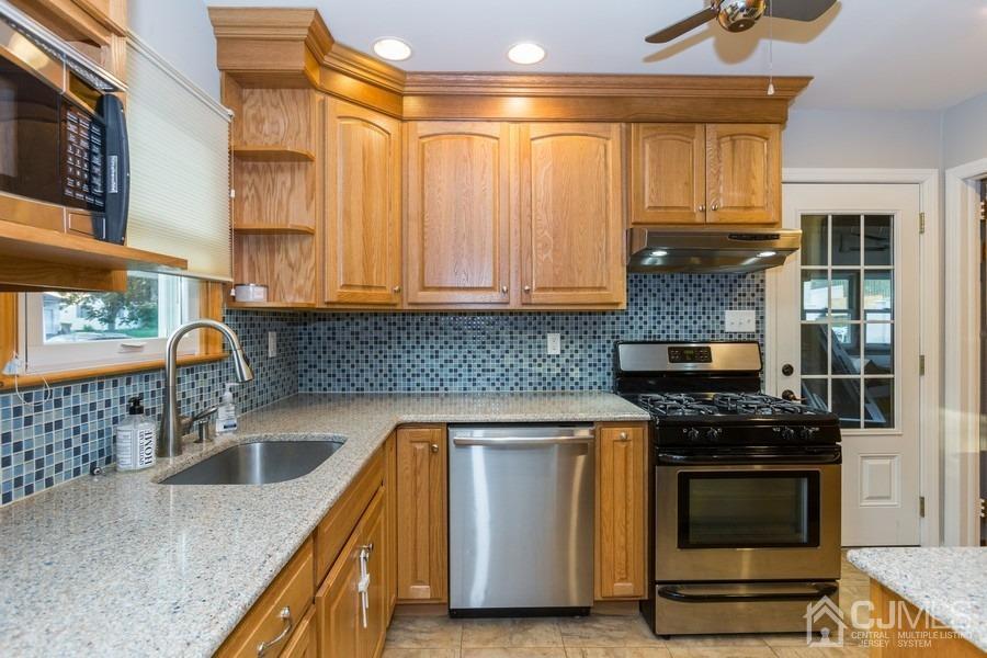 10 Yale Road Old Bridge, NJ 08859 - Photo 4 of 16 a kitchen with granite countertop a stove and a sink