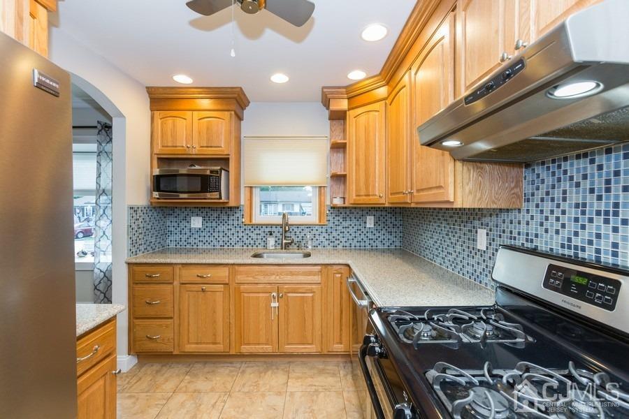 10 Yale Road Old Bridge, NJ 08859 - Photo 5 of 16 a kitchen with stainless steel appliances granite countertop a stove a sink and a microwave