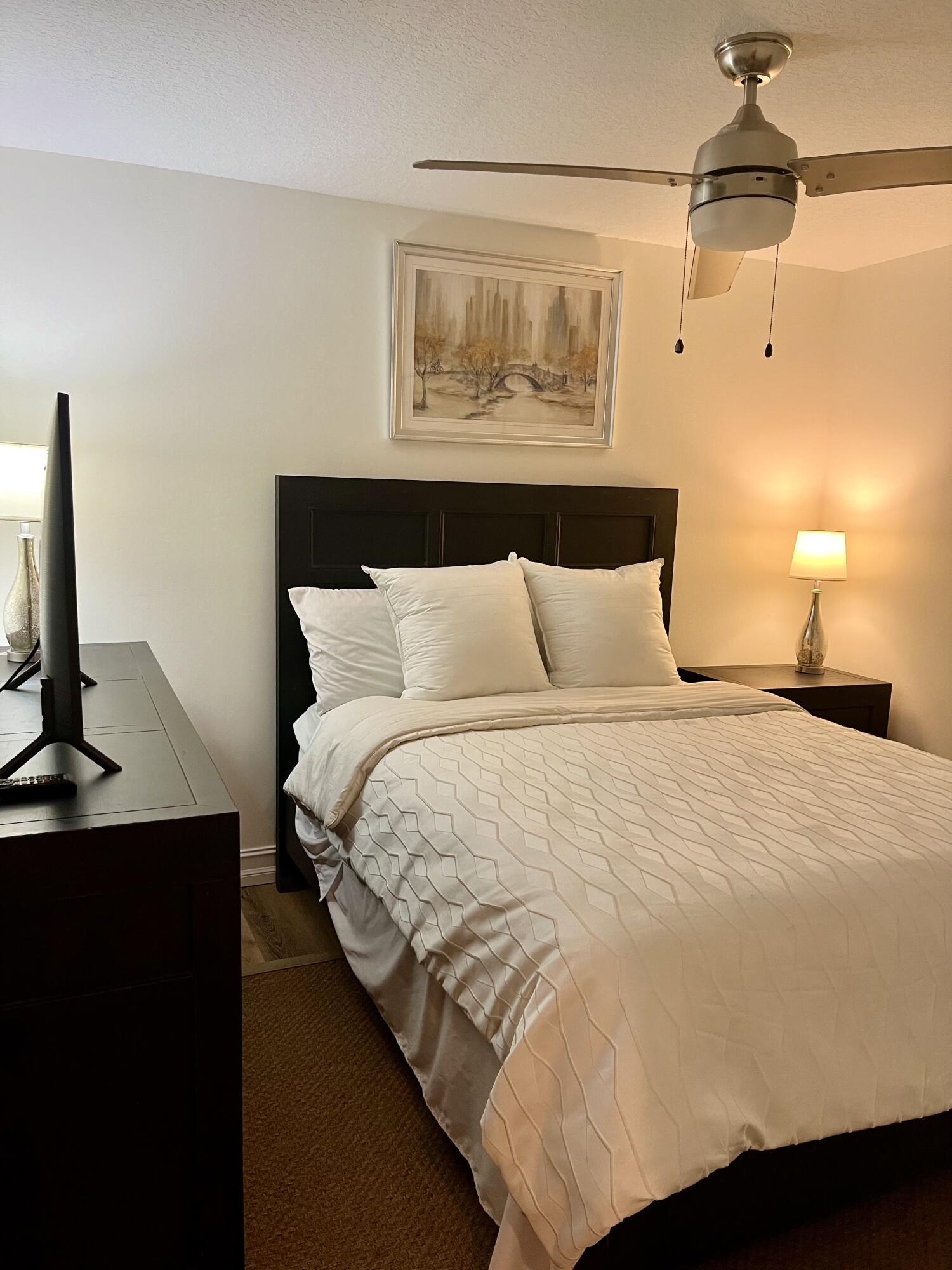 6882 3rd Street Limestone Creek, FL 33458 - Photo 11 of 17 a bedroom with a bed and a flat tv screen on the table