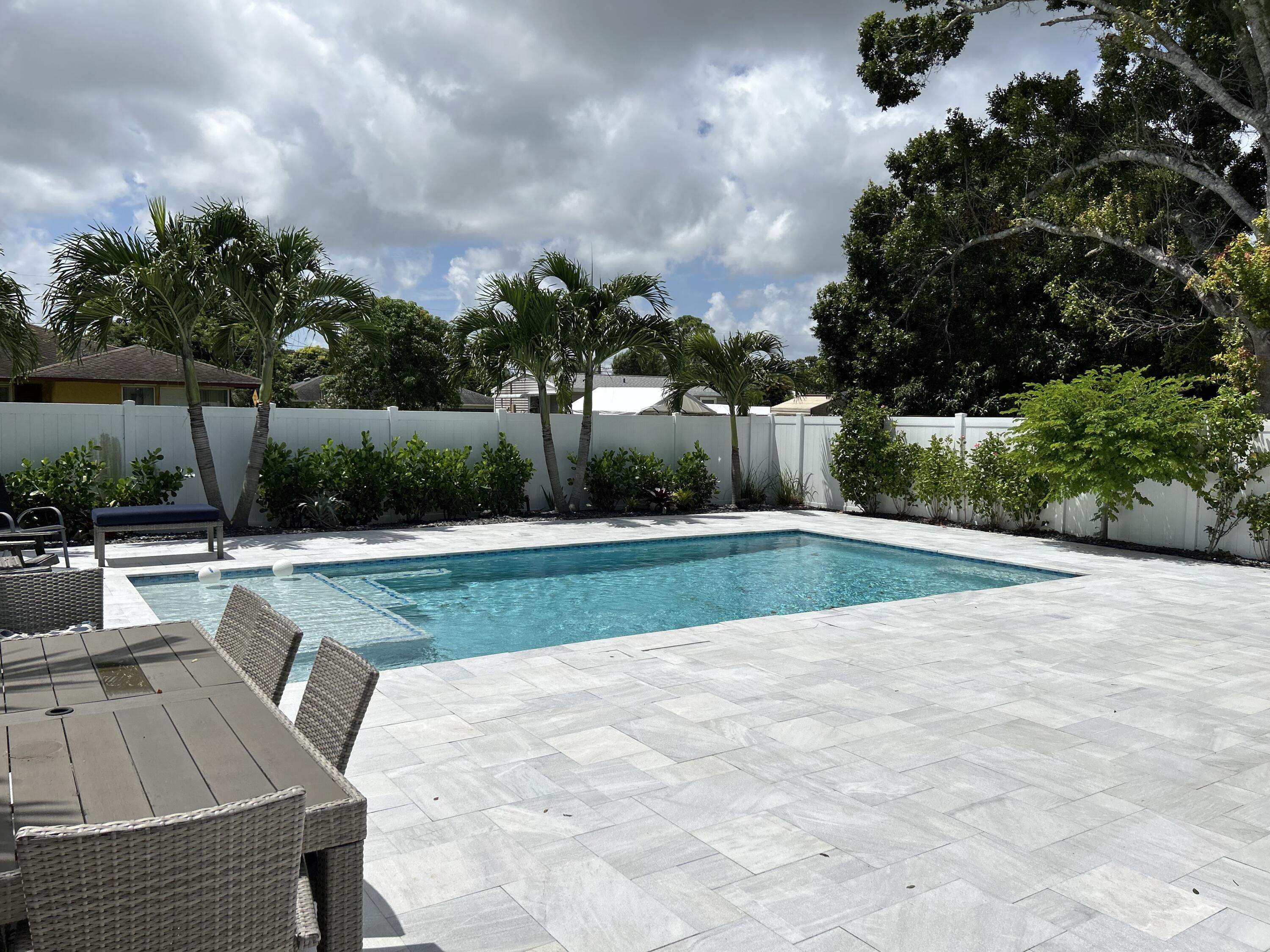 6882 3rd Street Limestone Creek, FL 33458 - Photo 14 of 17 a view of backyard with swimming pool and seating space