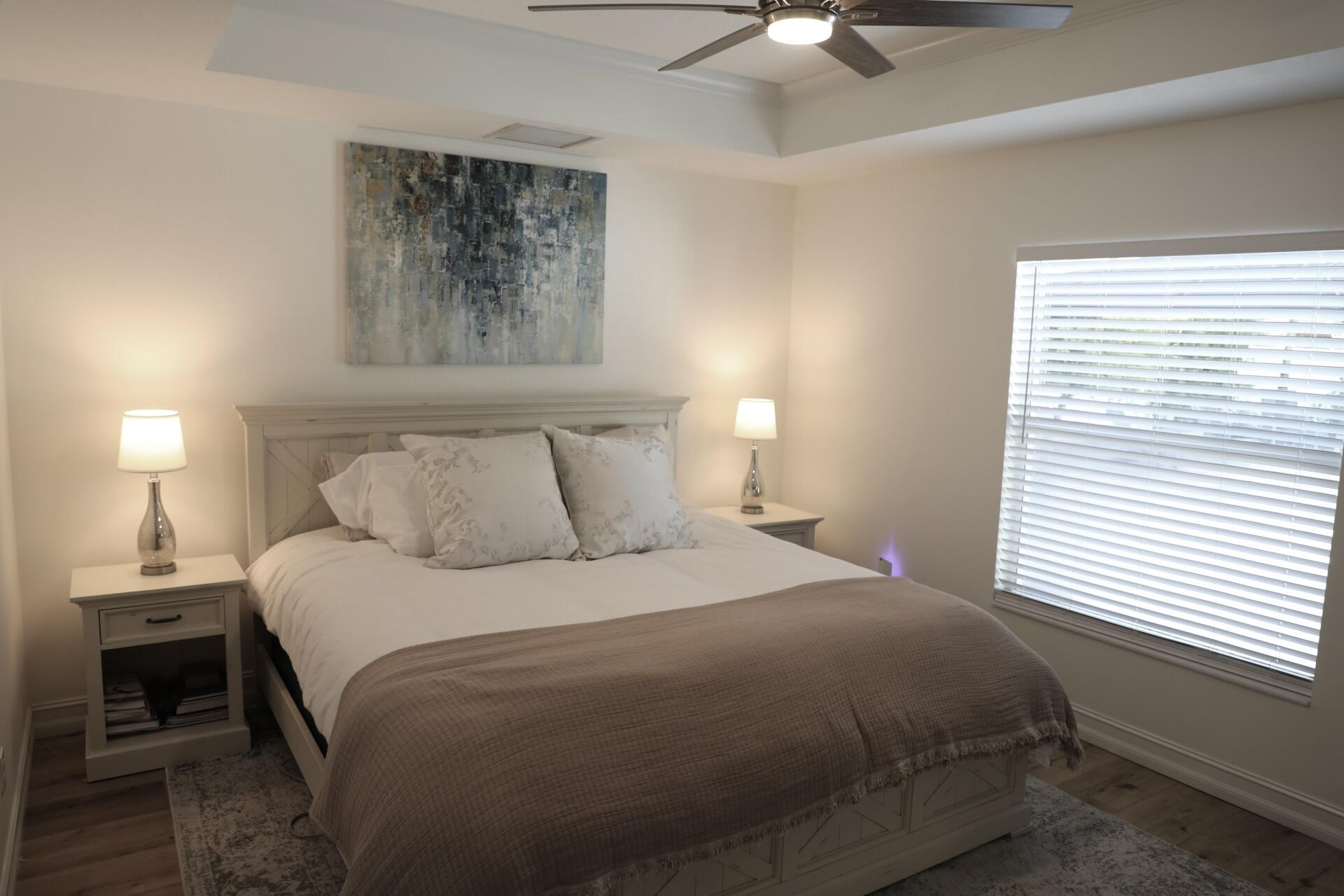 6882 3rd Street Limestone Creek, FL 33458 - Photo 8 of 17 a bedroom with a bed and a window