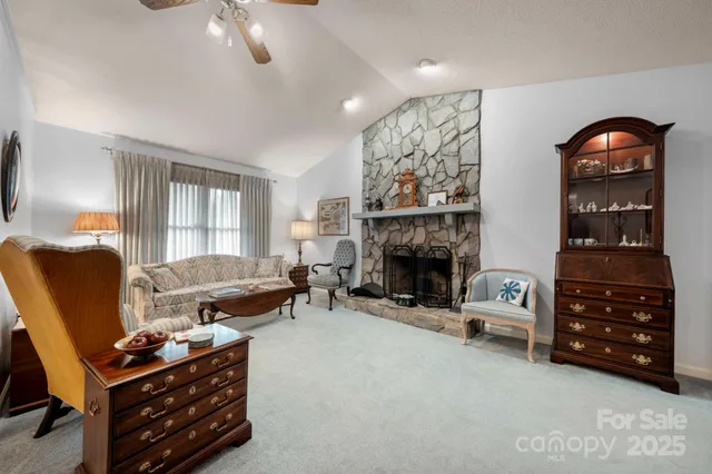 a living room with furniture and a dining table