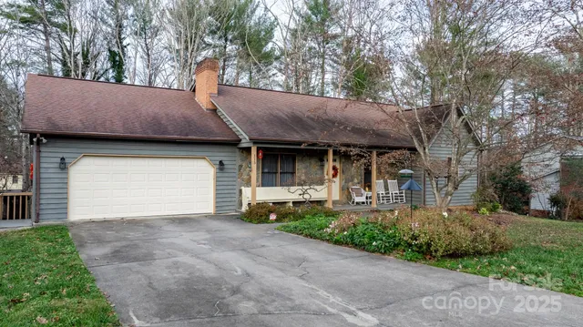 a front view of a house with a garden and garage