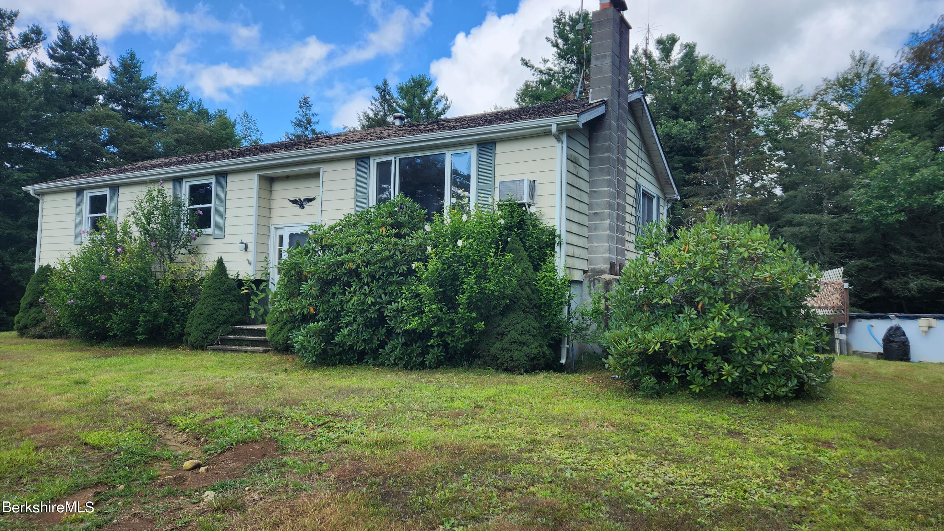 1156 Monterey Road Otis, MA 01253 - Photo 1 of 11 a view of a house with a yard and plants