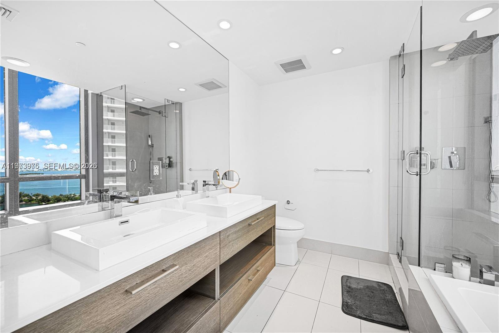 650 Northeast 32nd Street, Unit 2007 Miami, FL 33137 - Photo 13 of 44 a spacious bathroom with a double vanity sink and a mirror