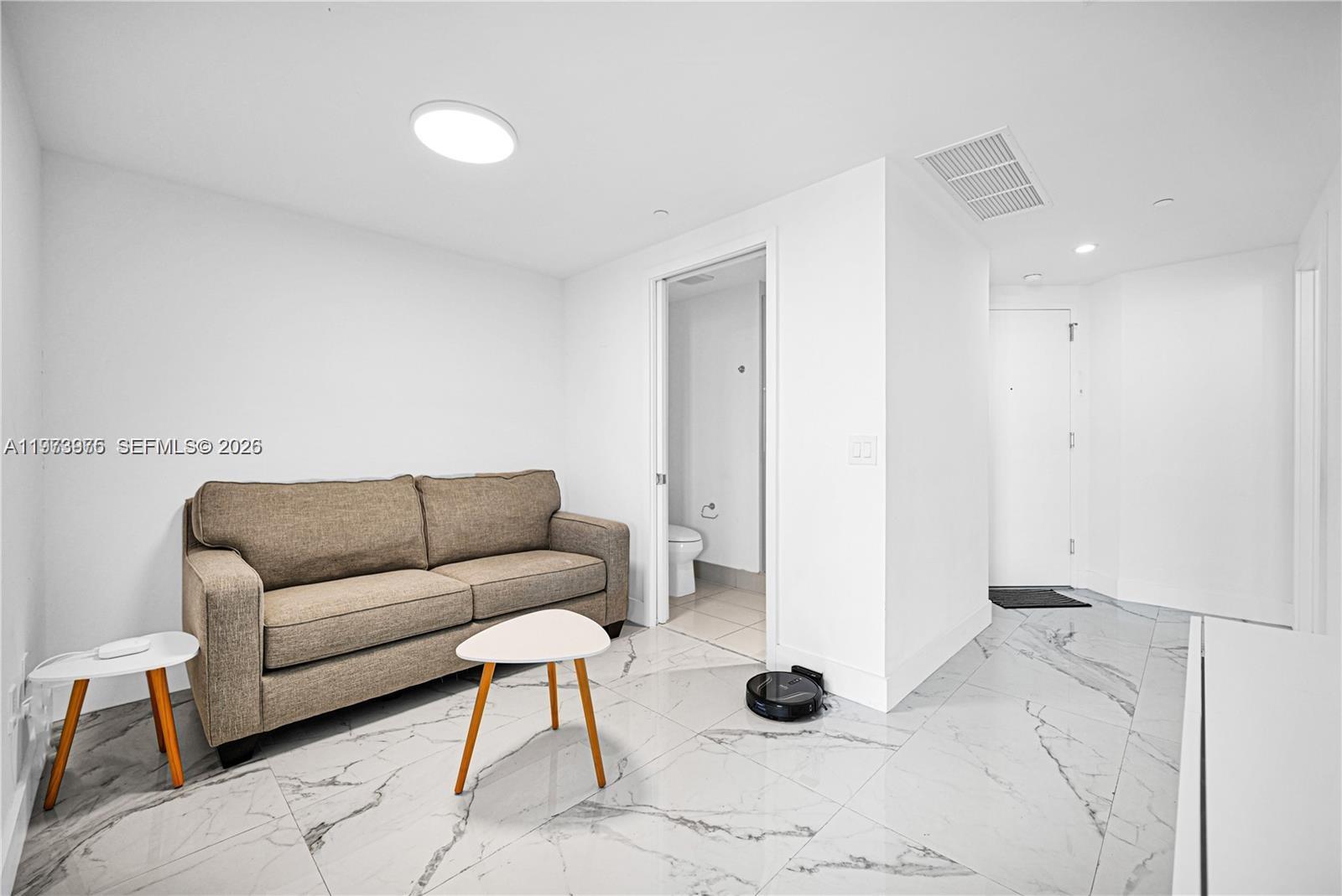 650 Northeast 32nd Street, Unit 2007 Miami, FL 33137 - Photo 16 of 44 a living room with a couch and a rug