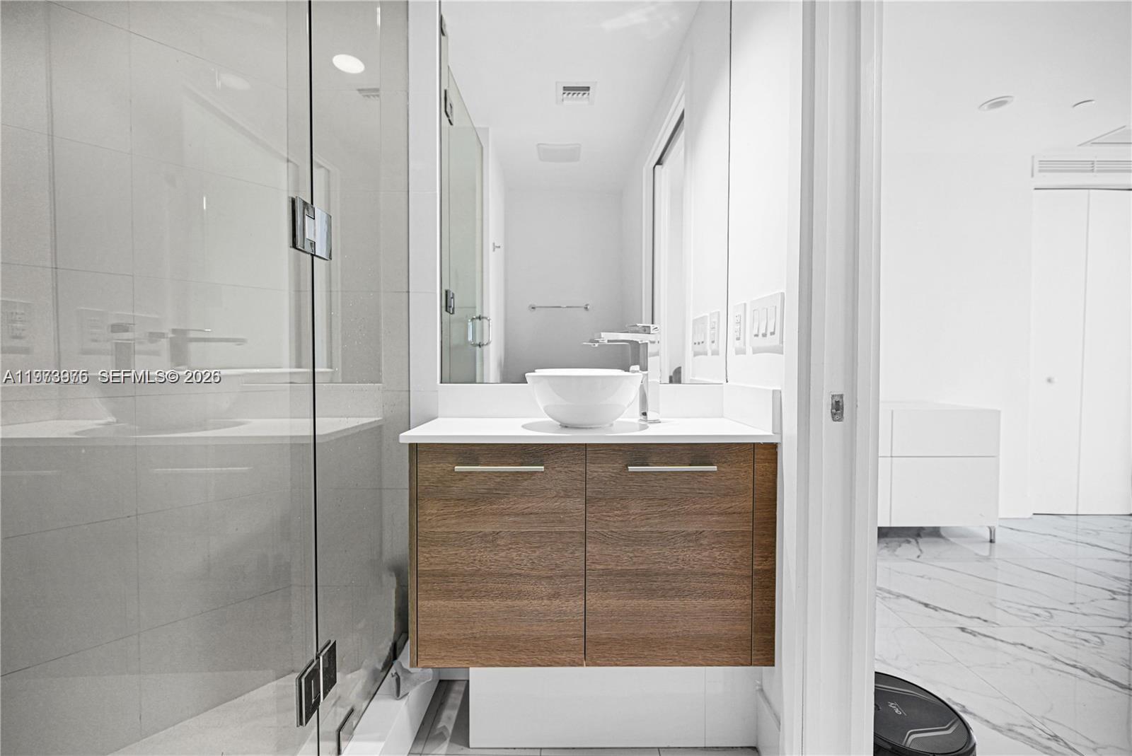 650 Northeast 32nd Street, Unit 2007 Miami, FL 33137 - Photo 18 of 44 a bathroom with a shower sink and mirror