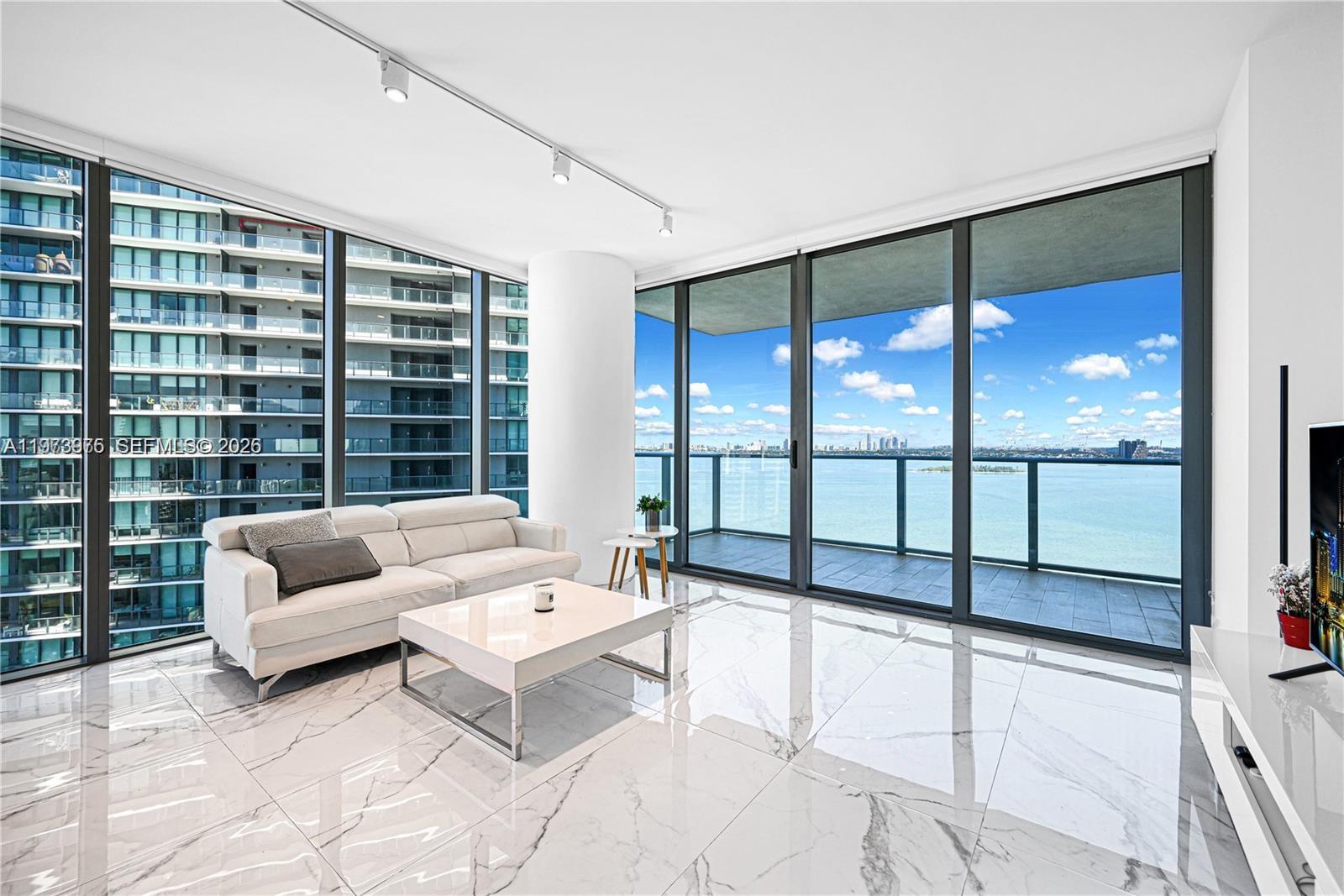 650 Northeast 32nd Street, Unit 2007 Miami, FL 33137 - Photo 2 of 44 a living room with furniture and a large window