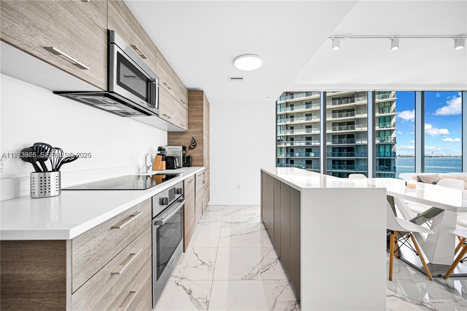 650 Northeast 32nd Street, Unit 2007 Miami, FL 33137 - Photo 3 of 44 a kitchen with a sink and cabinets