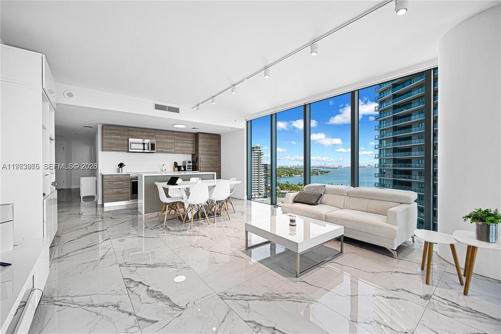 650 Northeast 32nd Street, Unit 2007 Miami, FL 33137 - Photo 7 of 44 a living room with furniture and large windows