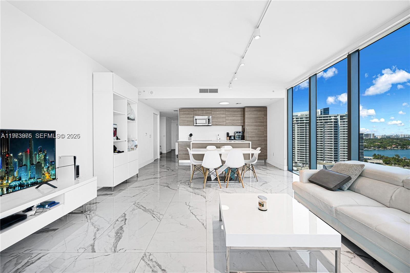 650 Northeast 32nd Street, Unit 2007 Miami, FL 33137 - Photo 9 of 44 a living room with furniture and a flat screen tv