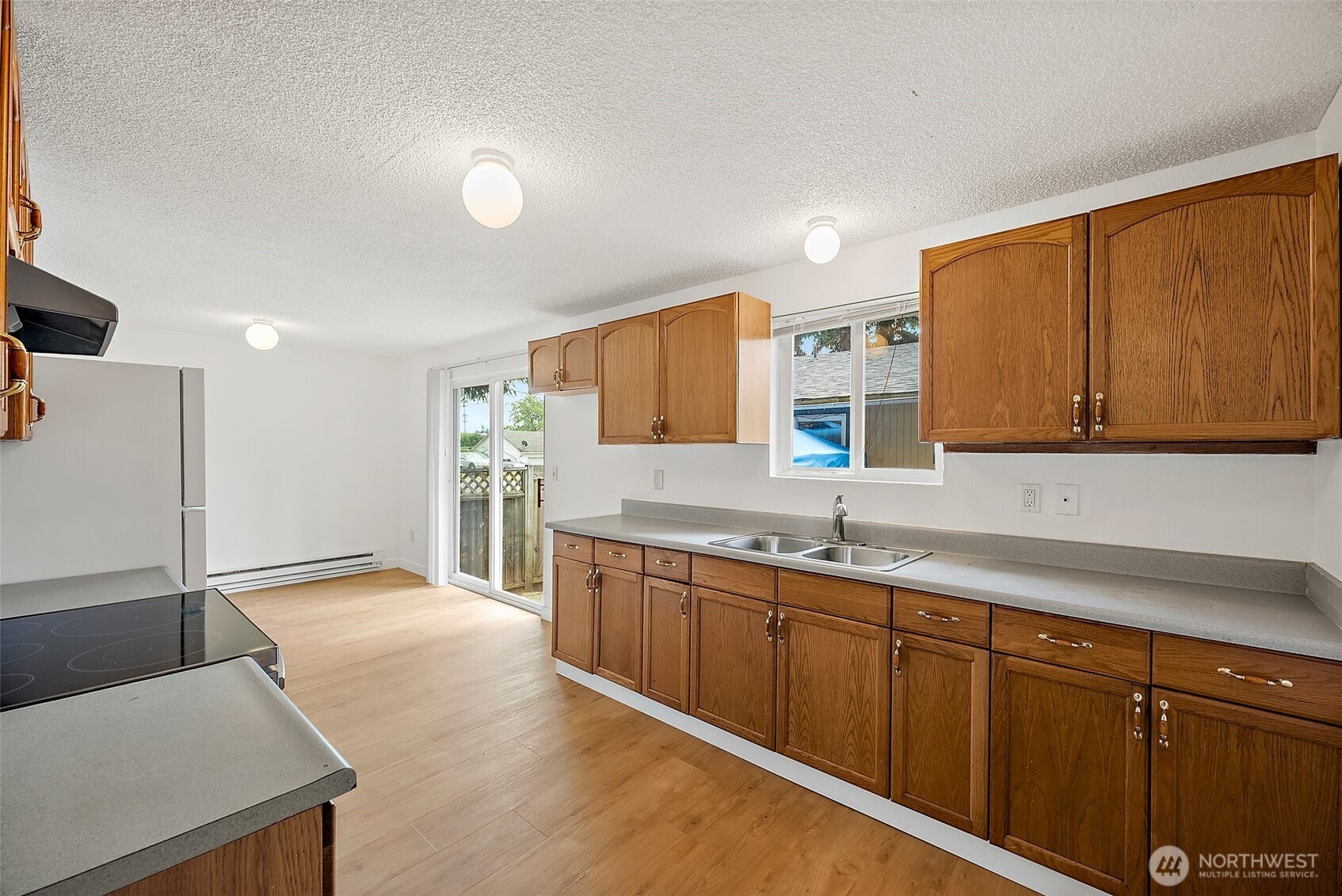 6610 South Madison Street Tacoma, WA 98409 - Photo 13 of 26 a view of a kitchen with stainless steel appliances granite countertop a sink and cabinets