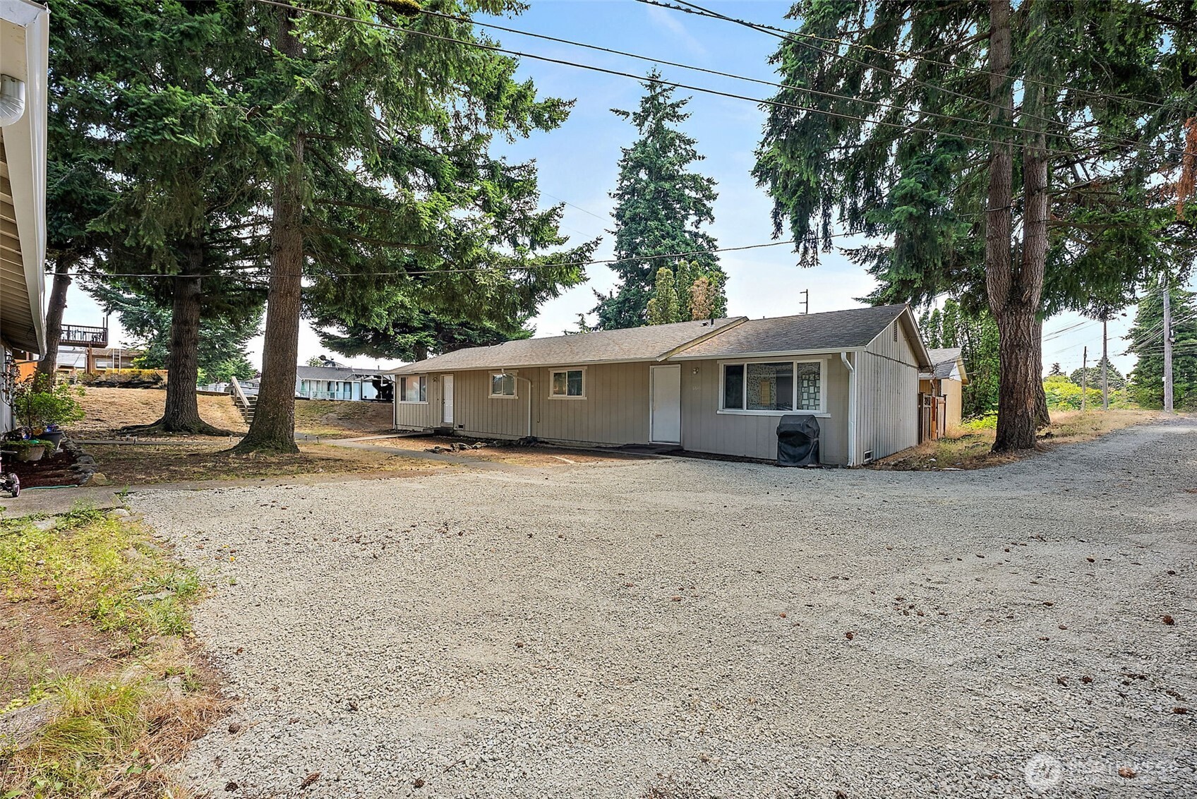 6610 South Madison Street Tacoma, WA 98409 - Photo 22 of 26 a view of a house with a yard and large tree