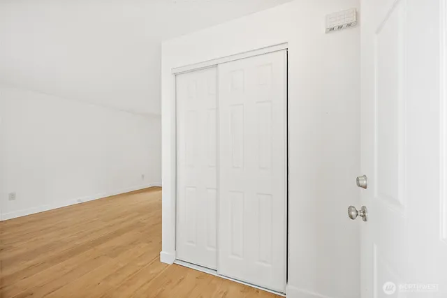a view of a room with wooden floor