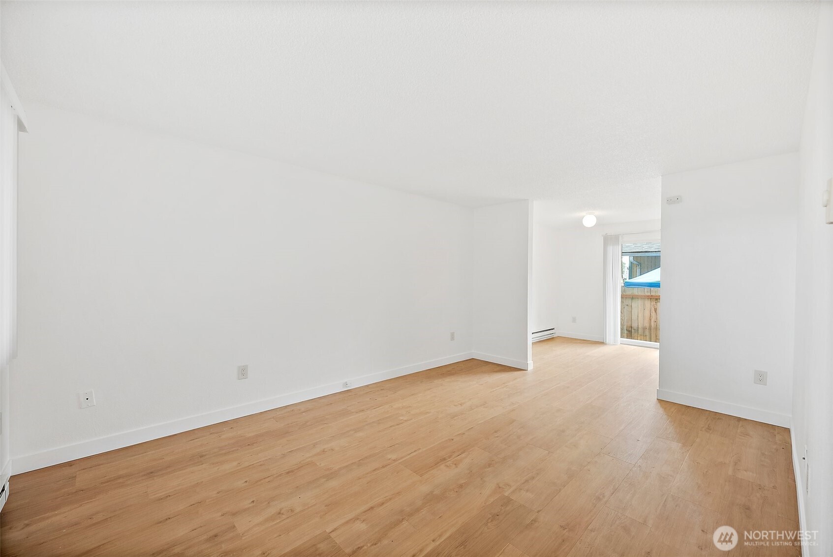 6610 South Madison Street Tacoma, WA 98409 - Photo 5 of 26 a view of an empty room with wooden floor