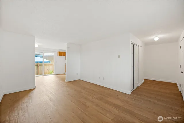 a view of empty room with wooden floor