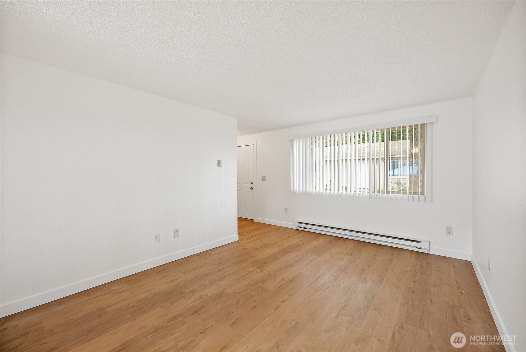 6610 South Madison Street Tacoma, WA 98409 - Photo 7 of 26 an empty room with wooden floor and windows