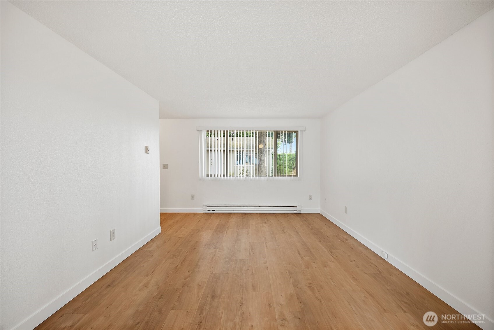 6610 South Madison Street Tacoma, WA 98409 - Photo 8 of 26 an empty room with wooden floor and windows