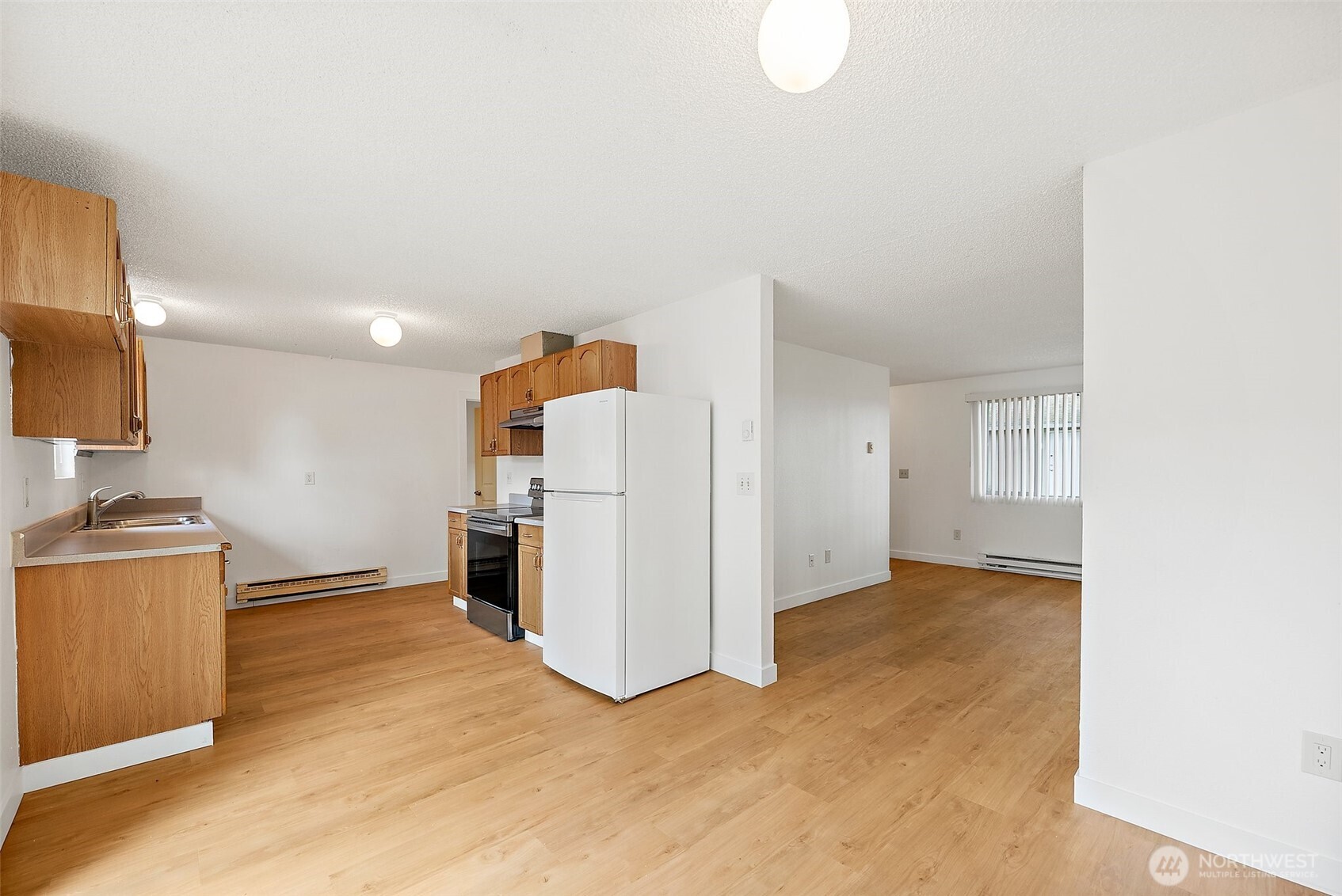 6610 South Madison Street Tacoma, WA 98409 - Photo 10 of 26 a view of a kitchen with a sink and a refrigerator