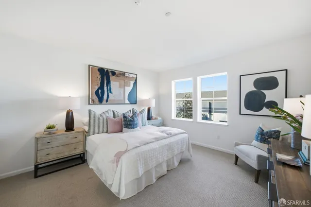 a bedroom with a bed and a lamp