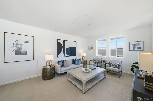 a living room with furniture a rug and a table