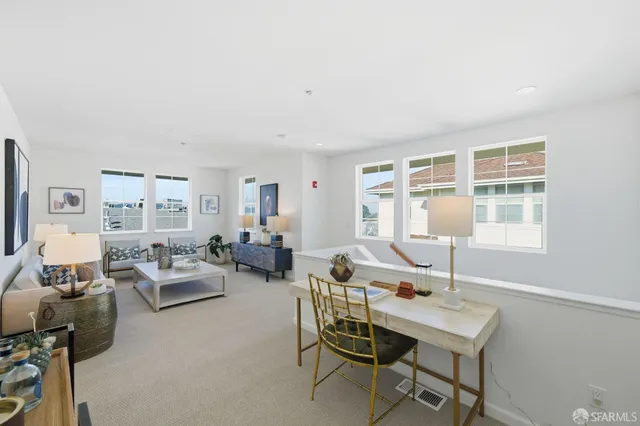 a living room with furniture and baby crib