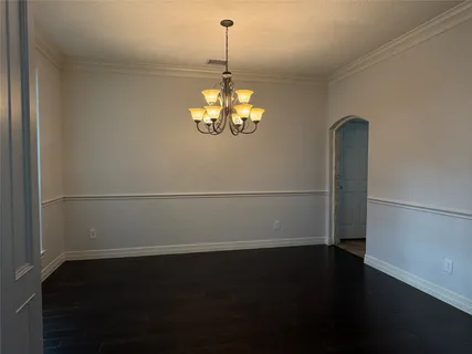 a view of a room with wooden floor and windows
