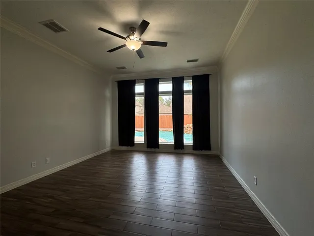 wooden floor in an empty room with a window