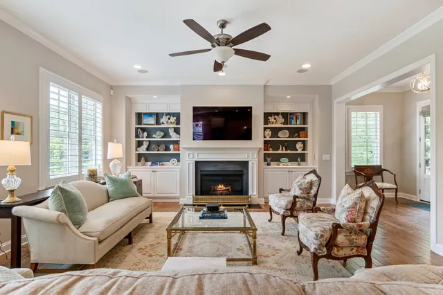 a living room with furniture cabinets and a flat screen tv