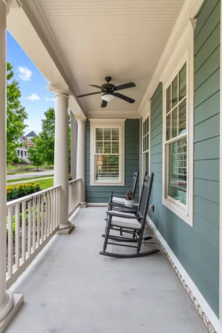 a kitchen with stainless steel appliances granite countertop a stove top oven a sink dishwasher a refrigerator and a dining table with wooden floor