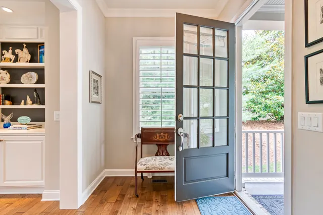 a view of a dining room with furniture a chandelier and wooden floor