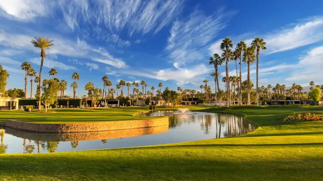a view of a swimming pool with a lawn chairs under an umbrella
