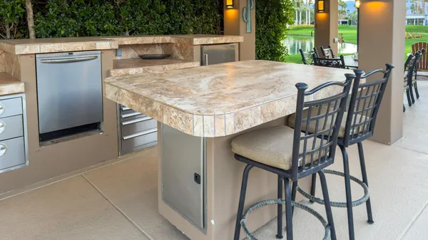 a view of a patio with a dining table and chairs with a garden view