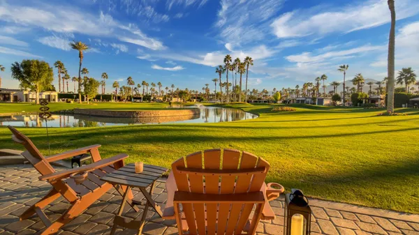 a view of a lake with a table and chairs
