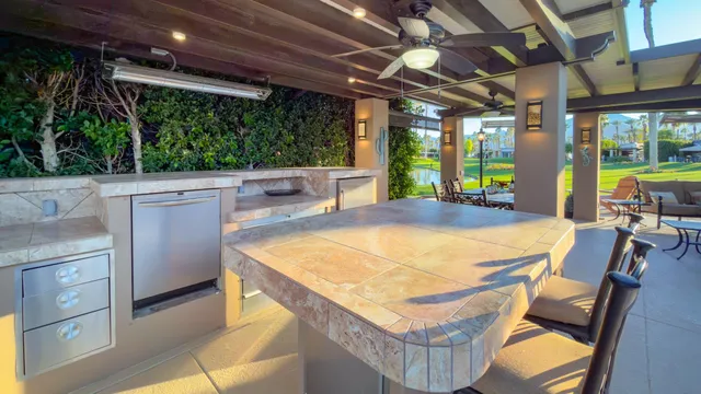 a view of a patio with a table and chairs
