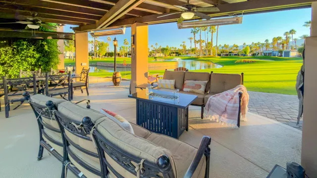 a view of a swimming pool with outdoor seating