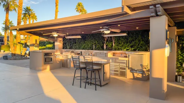 a view of a patio with a table and chairs