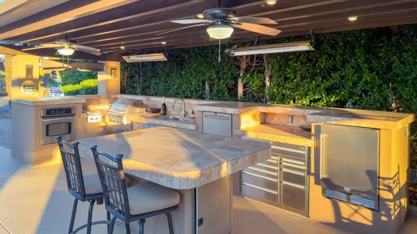 a view of an outdoor dining space with a table and chairs