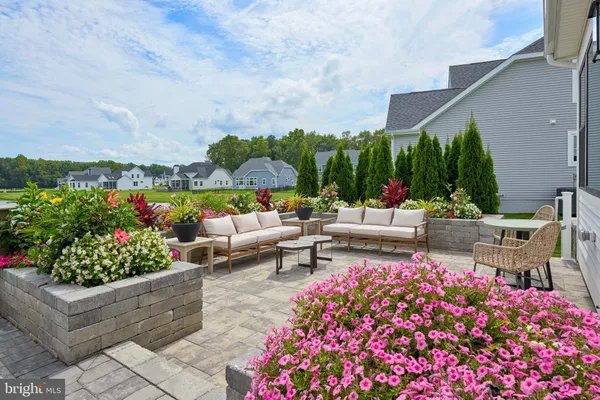 a view of a patio with couches and potted plants
