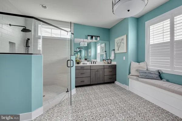 a en suite bathroom with a double vanity sink a mirror and a shower