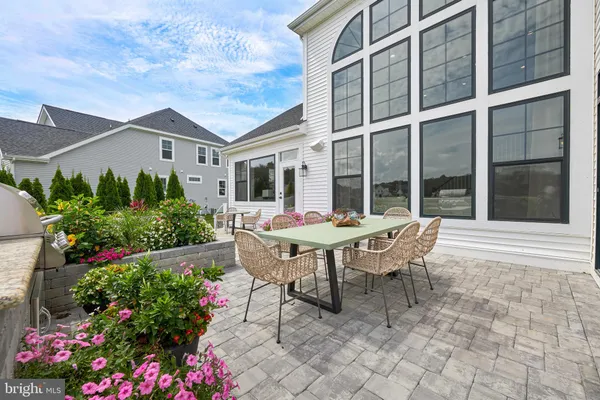 a backyard of a house with table and chairs