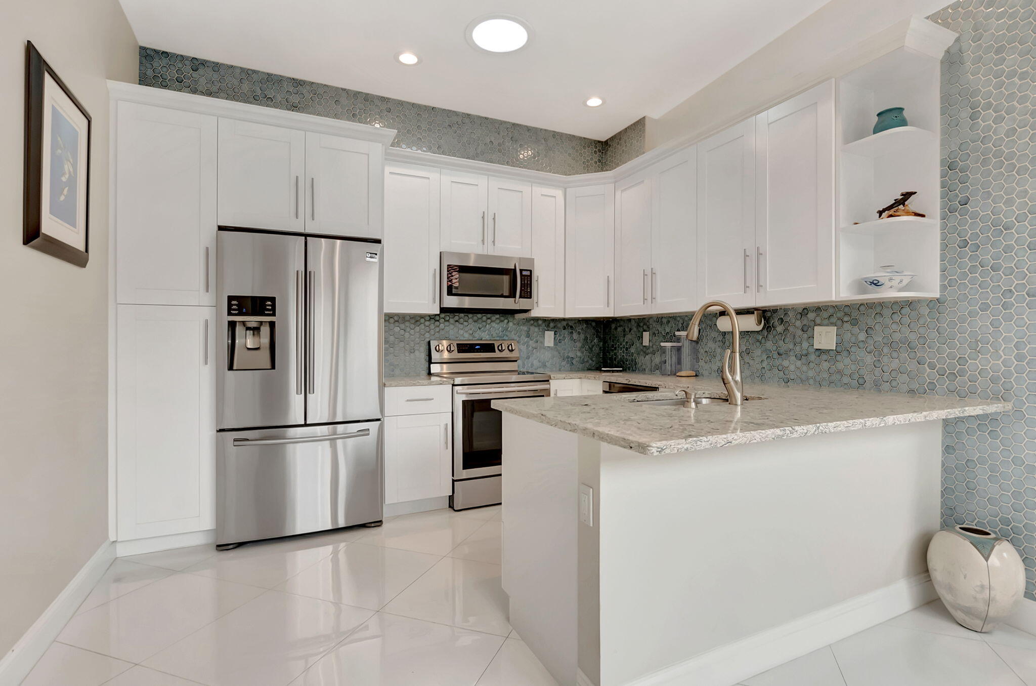 23164 Via Stel Boca Raton, FL 33433 - Photo 11 of 35 a kitchen with appliances a sink and a refrigerator