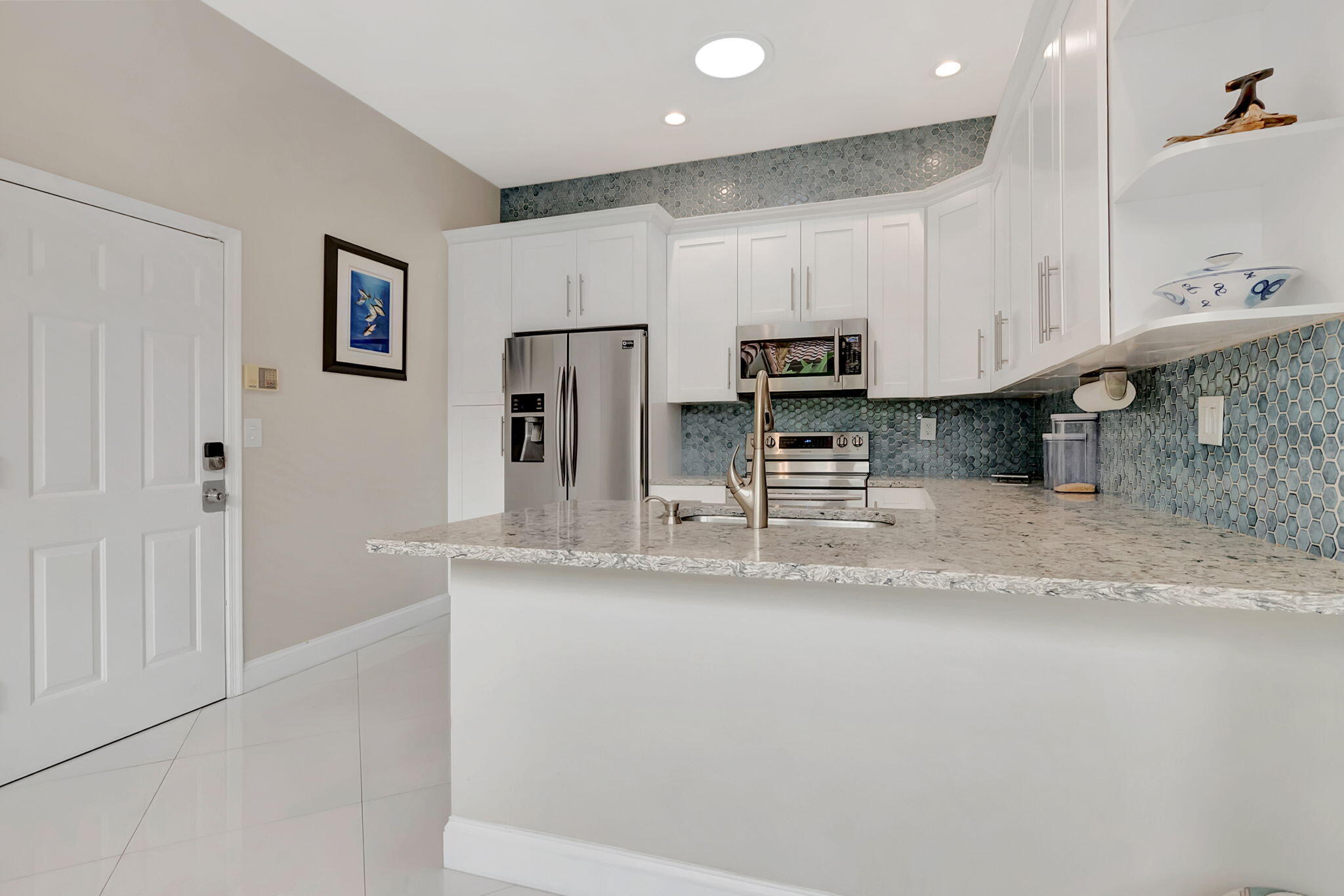 23164 Via Stel Boca Raton, FL 33433 - Photo 12 of 35 a kitchen with stainless steel appliances granite countertop a refrigerator a stove a sink and a granite counter tops