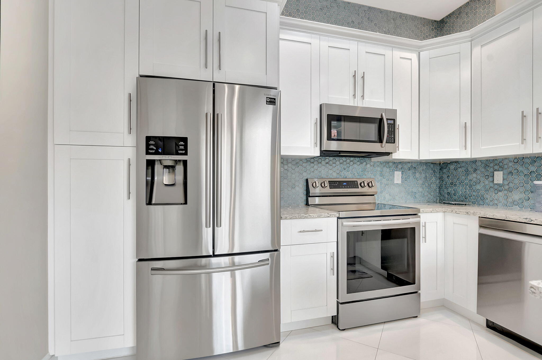 23164 Via Stel Boca Raton, FL 33433 - Photo 14 of 35 a white refrigerator freezer and a stove in a kitchen
