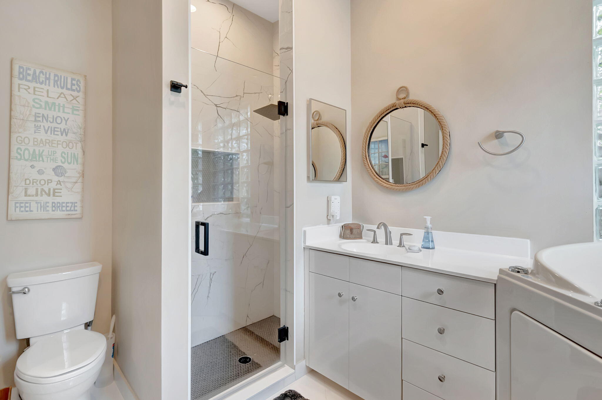 23164 Via Stel Boca Raton, FL 33433 - Photo 21 of 35 a bathroom with a toilet sink vanity and mirror